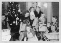Julfirande hos Månssons i Edared. Från vänster: Carl, Thora, Helene, Tomten, Inga-Maj, Karin, Birgitta, Osmo, Judit. Foto ca 1943.
